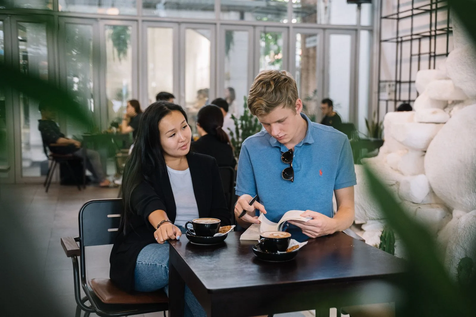 Two people in a warm, one-to-one conversation over coffee