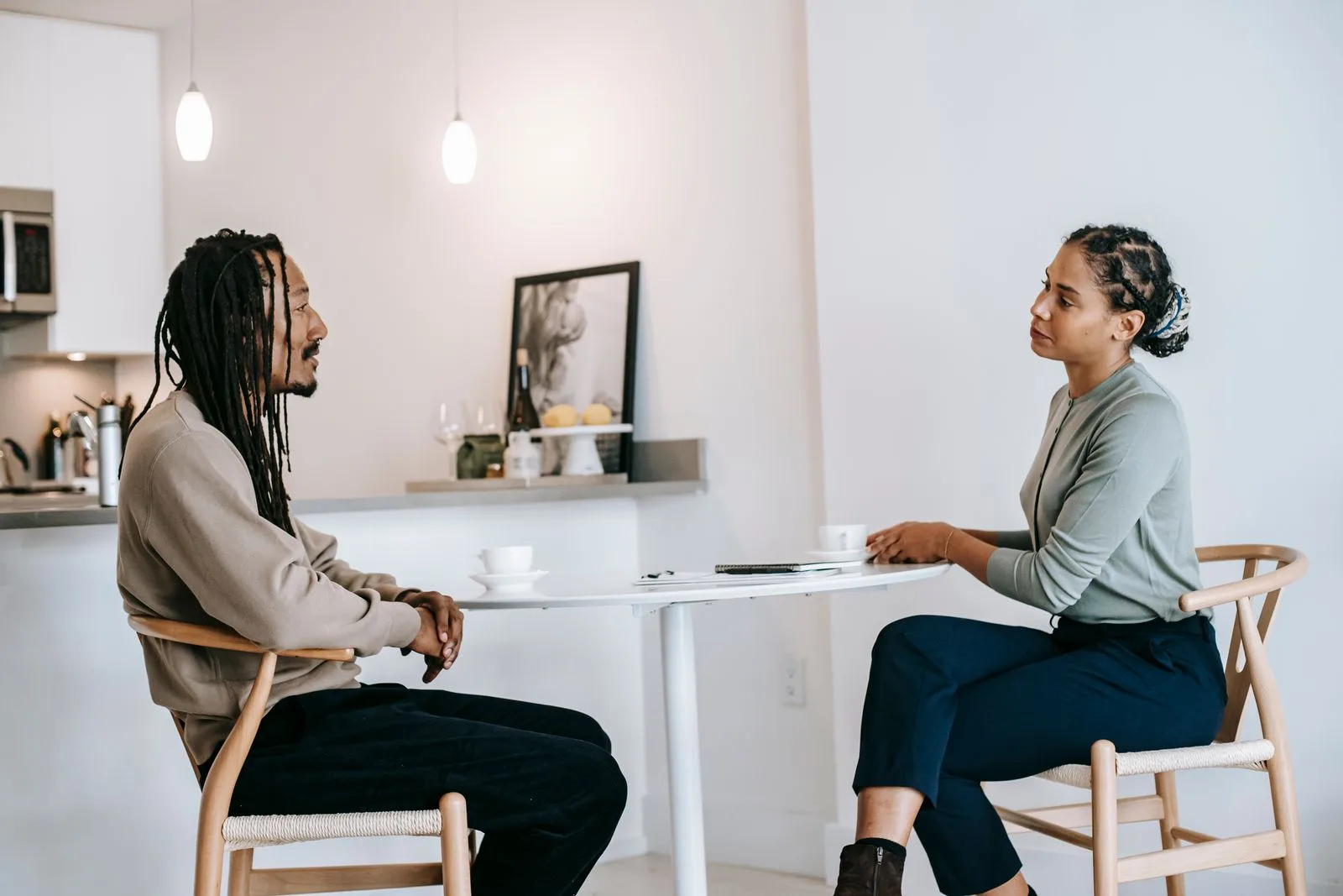 Two people sitting together in an honest, attentive deep conversation at home