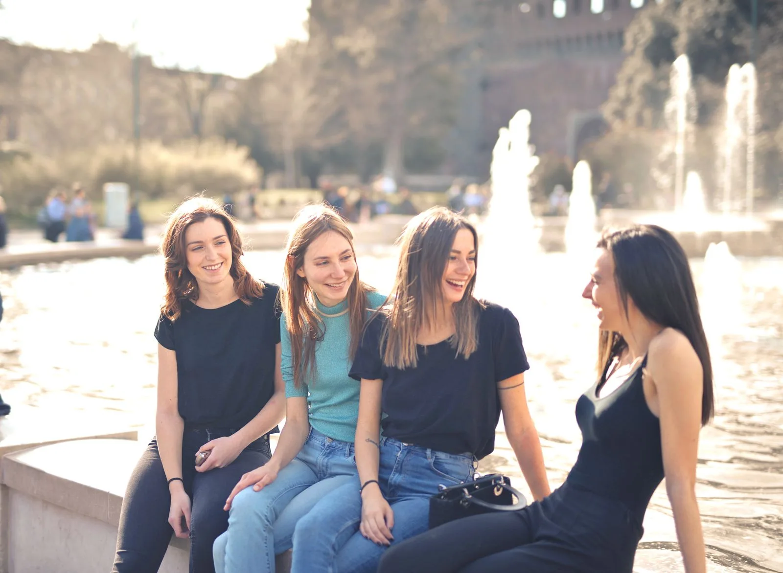 Four friends laughing together in warm light — the genuine connection that overcomes loneliness