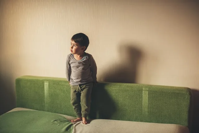 Person reflecting on childhood trauma and its lasting effects