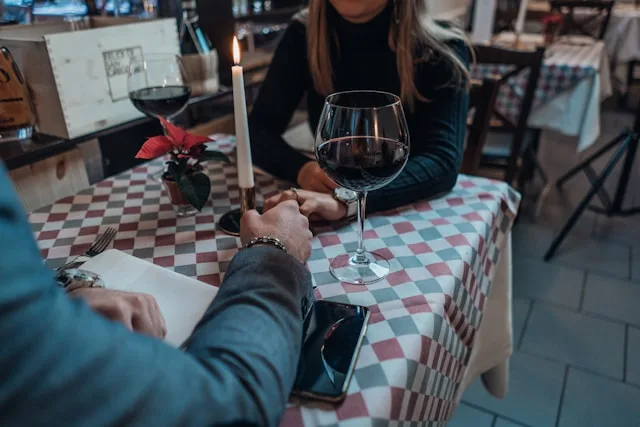 A couple talking openly across a table — the honest conversation that ends the limbo