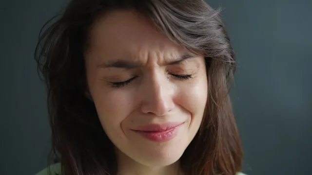 Person sitting alone experiencing emotional pain after breakup and deep sadness