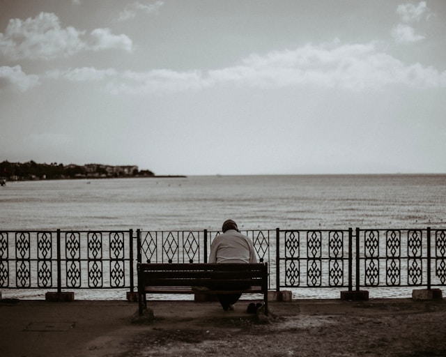 Person experiencing loneliness after loss and coping with grief in solitude