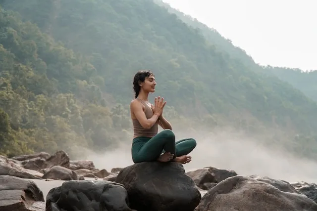 Person practicing meditation to calm the mind and body