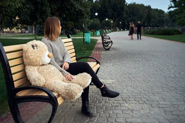 Person sitting alone practicing the no contact rule after a relationship breakup