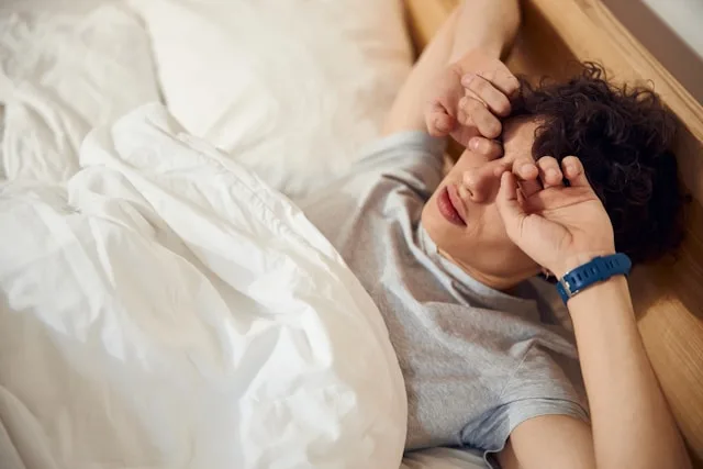 Person overthinking at night while lying awake