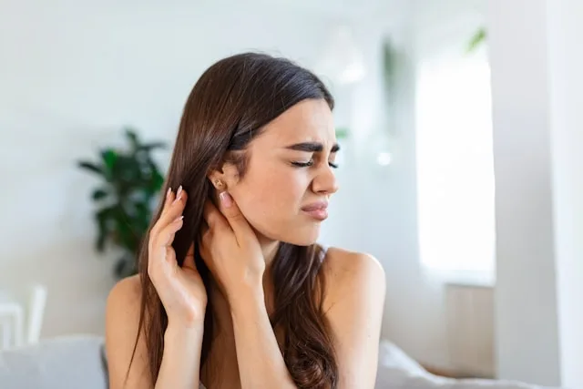 Person experiencing physical symptoms of stress affecting the body