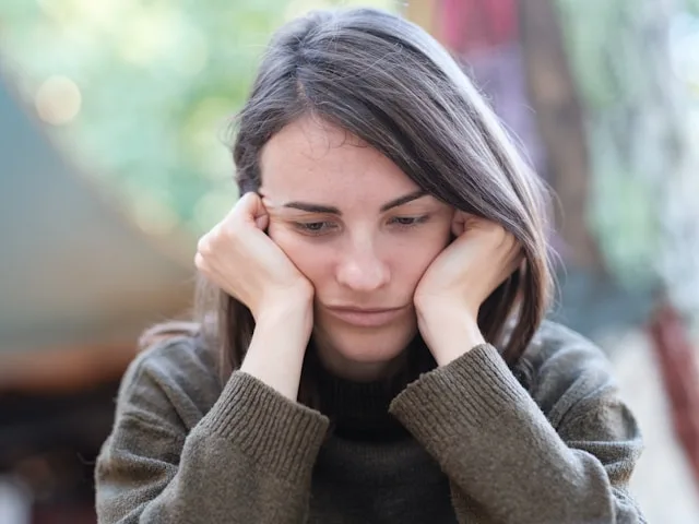 Person sitting alone feeling anxiety without reason and inner unease