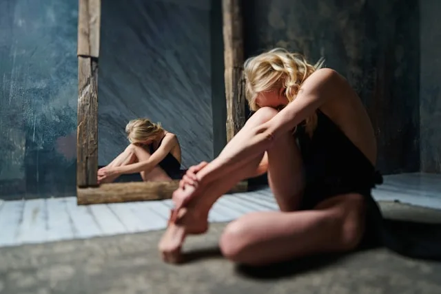 Person experiencing guilt and inner conflict while processing difficult emotions