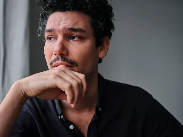 Person experiencing inner struggle and emotional conflict within themselves