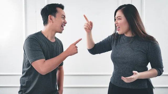 Two people experiencing miscommunication and misunderstanding in a conversation