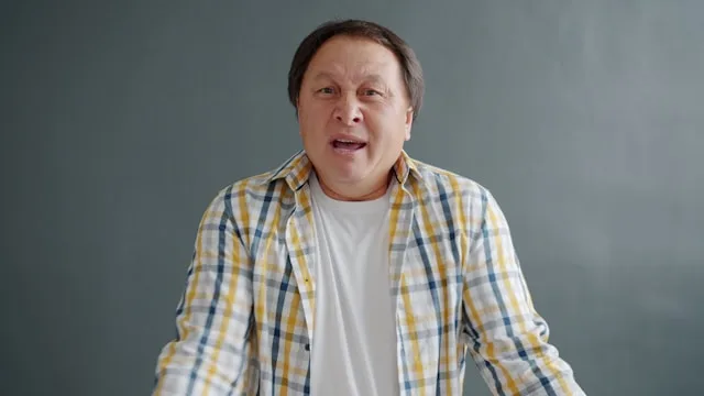 A person speaking expressively, using tone and gesture to communicate