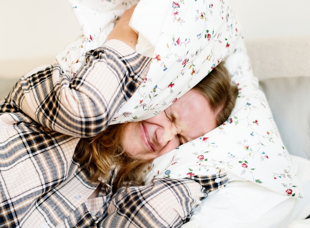 Person experiencing sleep and emotional stress affecting rest and recovery
