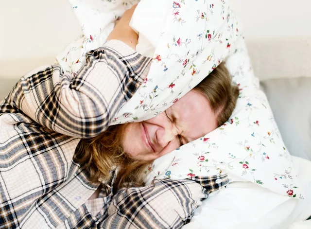 Person experiencing sleep and emotional stress affecting rest and recovery